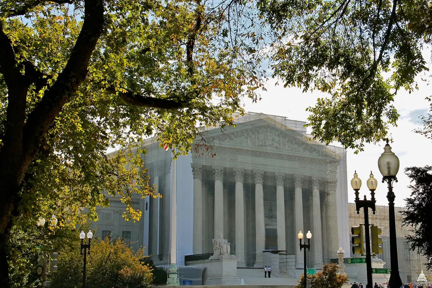 The west facade of the United States Supreme Court building, a white marble portico with fluted columns beneath a sculpted pediment.